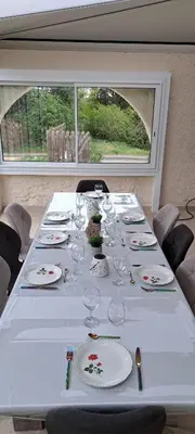 a long table with wine glasses and plates on it at Le nid du canal in Pezens