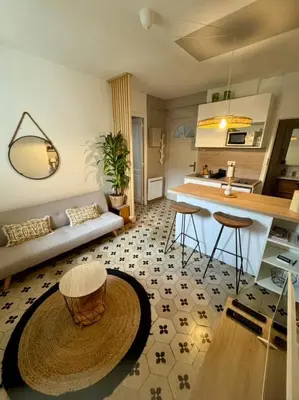 a living room with a couch and a table at Le BEHNA - Wi-Fi Apartment - Air Conditioning in Narbonne