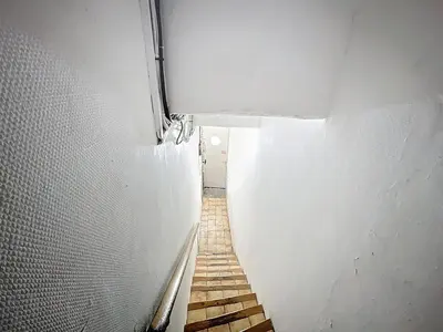 a stairway in a white wall with a stair case at Le BEHNA - Wi-Fi Apartment - Air Conditioning in Narbonne