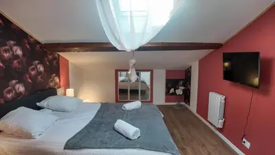 a bedroom with a large bed with white pillows at COSY APPARTEMENT INDEPENDANT I 2 LITS l 1 CHAMBRE I 2 TV I Netflix l Terrasse in Castres