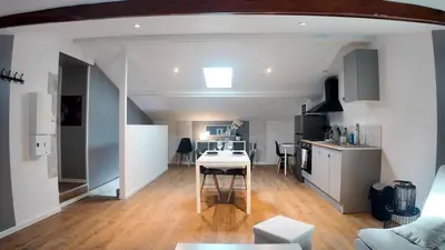 a kitchen and living room with a table in a room at COSY APPARTEMENT INDEPENDANT I 2 LITS l 1 CHAMBRE I 2 TV I Netflix l Terrasse in Castres