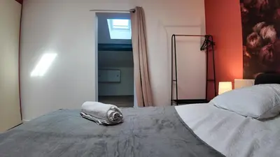 a bedroom with a bed with a towel on it at COSY APPARTEMENT INDEPENDANT I 2 LITS l 1 CHAMBRE I 2 TV I Netflix l Terrasse in Castres