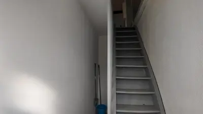 a staircase in a room with a stair case at COSY APPARTEMENT INDEPENDANT I 2 LITS l 1 CHAMBRE I 2 TV I Netflix l Terrasse in Castres