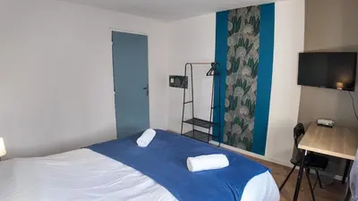 a bedroom with a bed with two towels on it at Elégant Appartement - 2 Chambres - Netflix - Terrasse in Castres