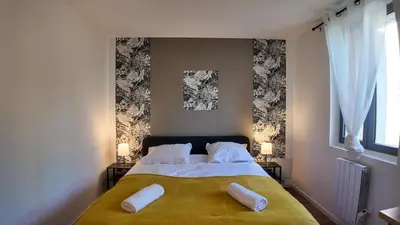 a bedroom with a bed with two pillows on it at Elégant Appartement - 2 Chambres - Netflix - Terrasse in Castres