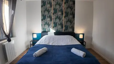a bedroom with a bed with two pillows on it at Elégant Appartement - 2 Chambres - Netflix - Terrasse in Castres