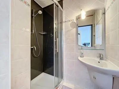 a bathroom with a shower and a sink at Le Thalio - Swimming pool - Air conditioning in Gruissan
