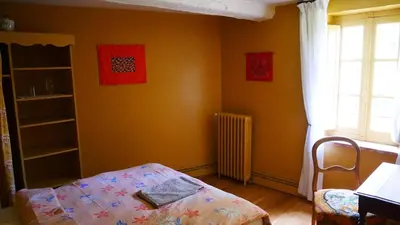 a bedroom with orange walls and a bed and a window at Maison Chérie Artisanal Farmhouse in Villarzel-du-Razès