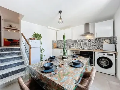 a kitchen with a table with bowls on top of it at Le Bohja - Charming apartment near Les Halles in Narbonne