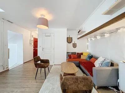 a living room with a couch and a table at Le Bohja - Charming apartment near Les Halles in Narbonne