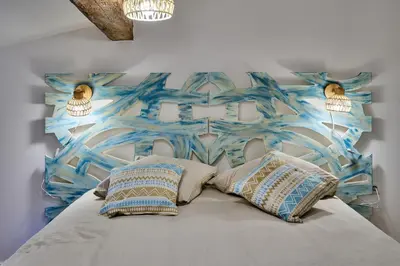 a bedroom with a bed with two pillows at Charme, confort en centre-ville in Limoux