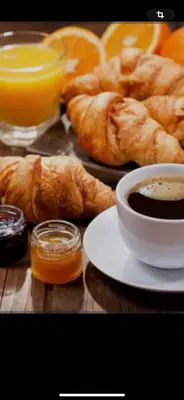 a table with a plate of croissants and orange juice at Ô banc de la vigne in Fabrezan