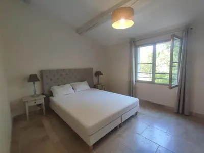 a bedroom with a white bed and a window at La Redorte 24 in La Redorte
