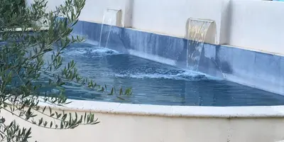 a water fountain in a pool in a building at La Redorte 24 in La Redorte