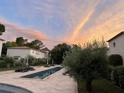 a swimming pool in a yard with a sunset at La Redorte 24 in La Redorte
