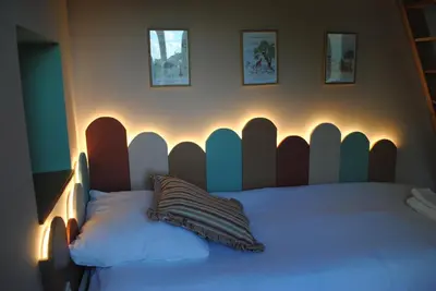 a bed with a headboard in a bedroom at L'Echiquier in Castres