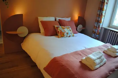 a bedroom with two beds with towels on them at L'Echiquier in Castres