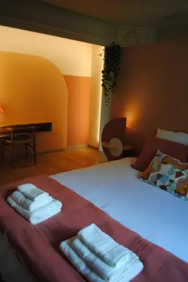 a bedroom with a bed with towels on it at L'Echiquier in Castres