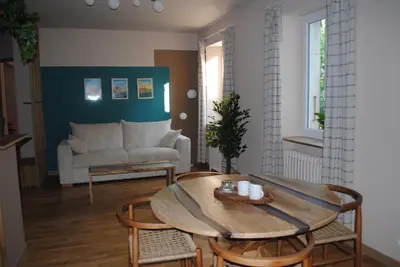 a living room with a table and chairs and a couch at L'Echiquier in Castres