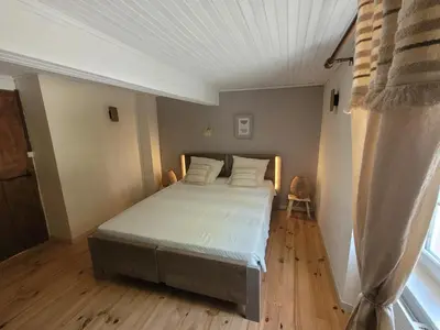 a bedroom with a bed and a white ceiling at Gîte le Courdel in Les Brunels
