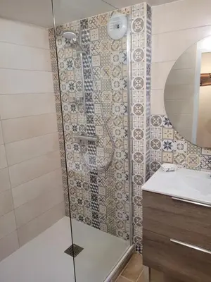a bathroom with a shower and a sink at Gîte le Courdel in Les Brunels