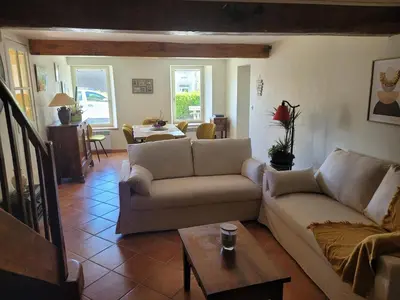 a living room with a couch and a table at Gîte le Courdel in Les Brunels