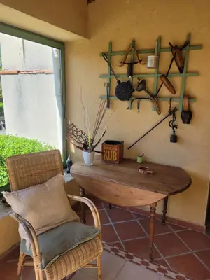 a room with a table and a chair and a window at Gîte le Courdel in Les Brunels