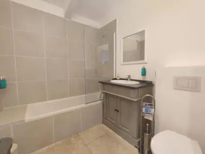 a bathroom with a sink and a tub and a toilet at La Redorte 17 in La Redorte