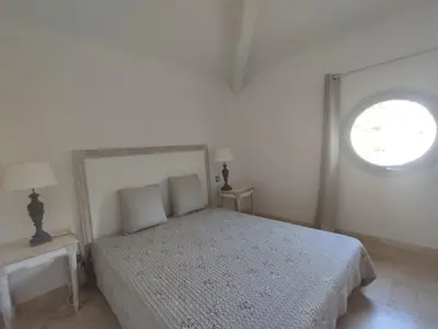 a bedroom with a bed with two tables and a window at La Redorte 17 in La Redorte