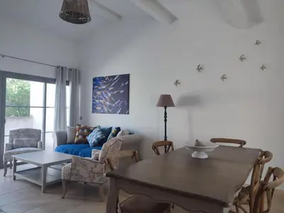 a living room with a table and a blue couch at La Redorte 17 in La Redorte