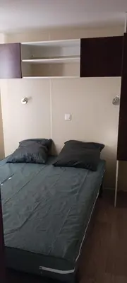 a bed with two pillows on it in a room at El sol in Port-la-Nouvelle