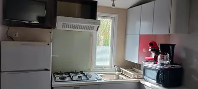 a kitchen with a stove and a sink and a window at El sol in Port-la-Nouvelle