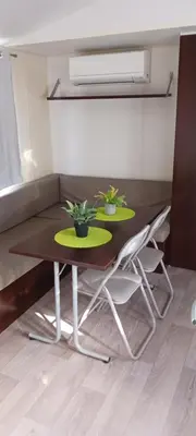 a dining room table with two plants on it at El sol in Port-la-Nouvelle