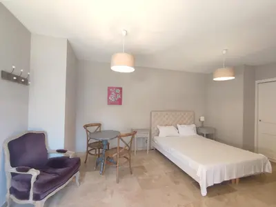 a bedroom with a bed and a table and chairs at La Redorte 29 in La Redorte