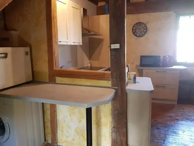 a kitchen with a counter top and a refrigerator at Vacances en pays cathare réservable du samedi au samedi les mois de Juillet et Aout in Joucou