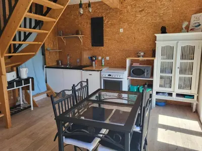 a small kitchen with a table and a stove at A la campagne in Saint-Denis