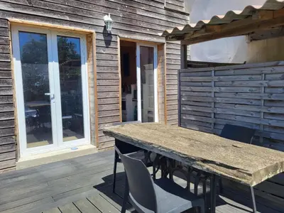 a wooden deck with a wooden table and chairs at A la campagne in Saint-Denis