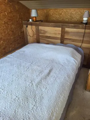 a bedroom with a white bed with two lamps on it at A la campagne in Saint-Denis