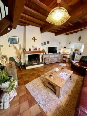 a living room with a table and a fireplace at Bienvenue chez Sandrine in La Redorte