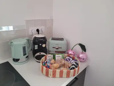 a basket of pastries on a counter in a kitchen at Le Baron terrasse et parking cœur de Castres in Castres