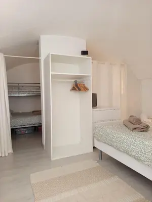 a white room with two beds and a closet at Ciel & Sel in Gruissan
