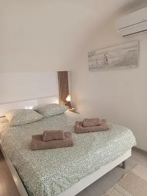 a bedroom with a bed with two towels on it at Ciel & Sel in Gruissan