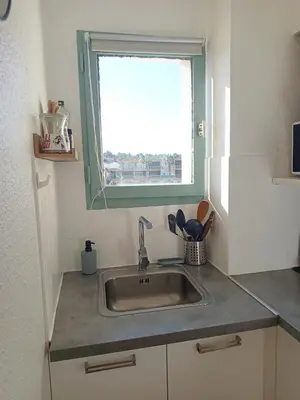 a small kitchen with a sink and a window at Ciel & Sel in Gruissan
