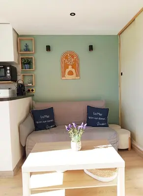 a living room with a couch and a table at Ciel & Sel in Gruissan