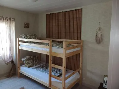 two bunk beds in a room with a window at Sidobre in Lacrouzette