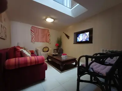 a living room with a couch and a tv at Sidobre in Lacrouzette