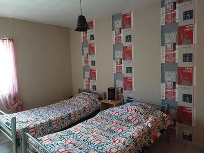two beds in a room with posters on the wall at Sidobre in Lacrouzette