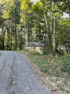 an old building on the side of a road at Large charming house surrounded by nature in Brassac