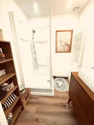a bathroom with a shower with a glass door at Large charming house surrounded by nature in Brassac