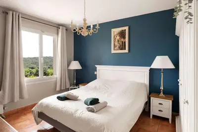 a bedroom with a bed with two towels on it at Villa La Cavayere swimming pool air conditioning in Carcassonne